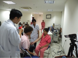 Dr Swinnen examining patient with Dr Nguyen Trong Hien interpreting